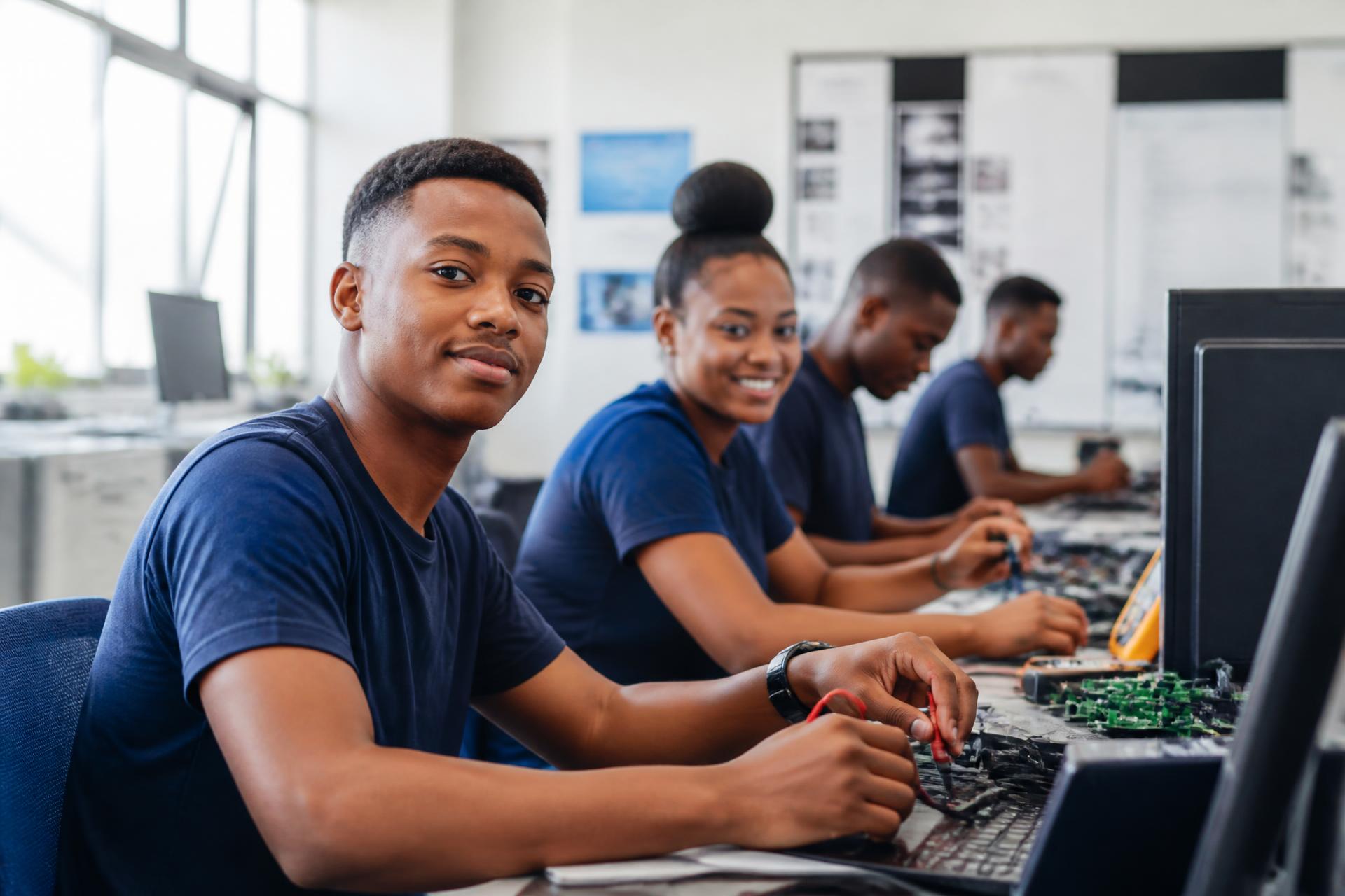 Young South Africans learning technical and IT skills in a training workshop